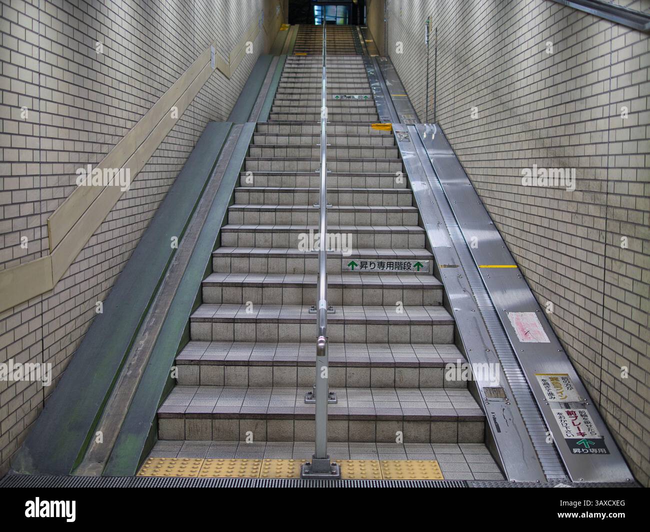 Stairway with guide rails and cycle and luggage conveyor in a subway ...