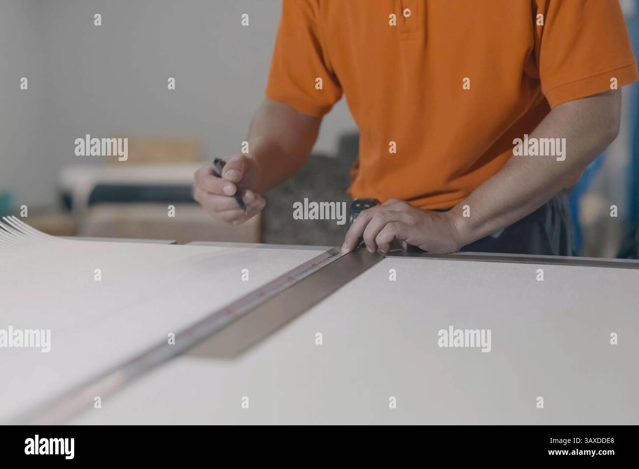 A Man Measures With A Tape Measure And Makes Marks With A Pencil Stock a-man-measures-with-a-tape-measure-and-makes-marks-with-a-pencil-stock