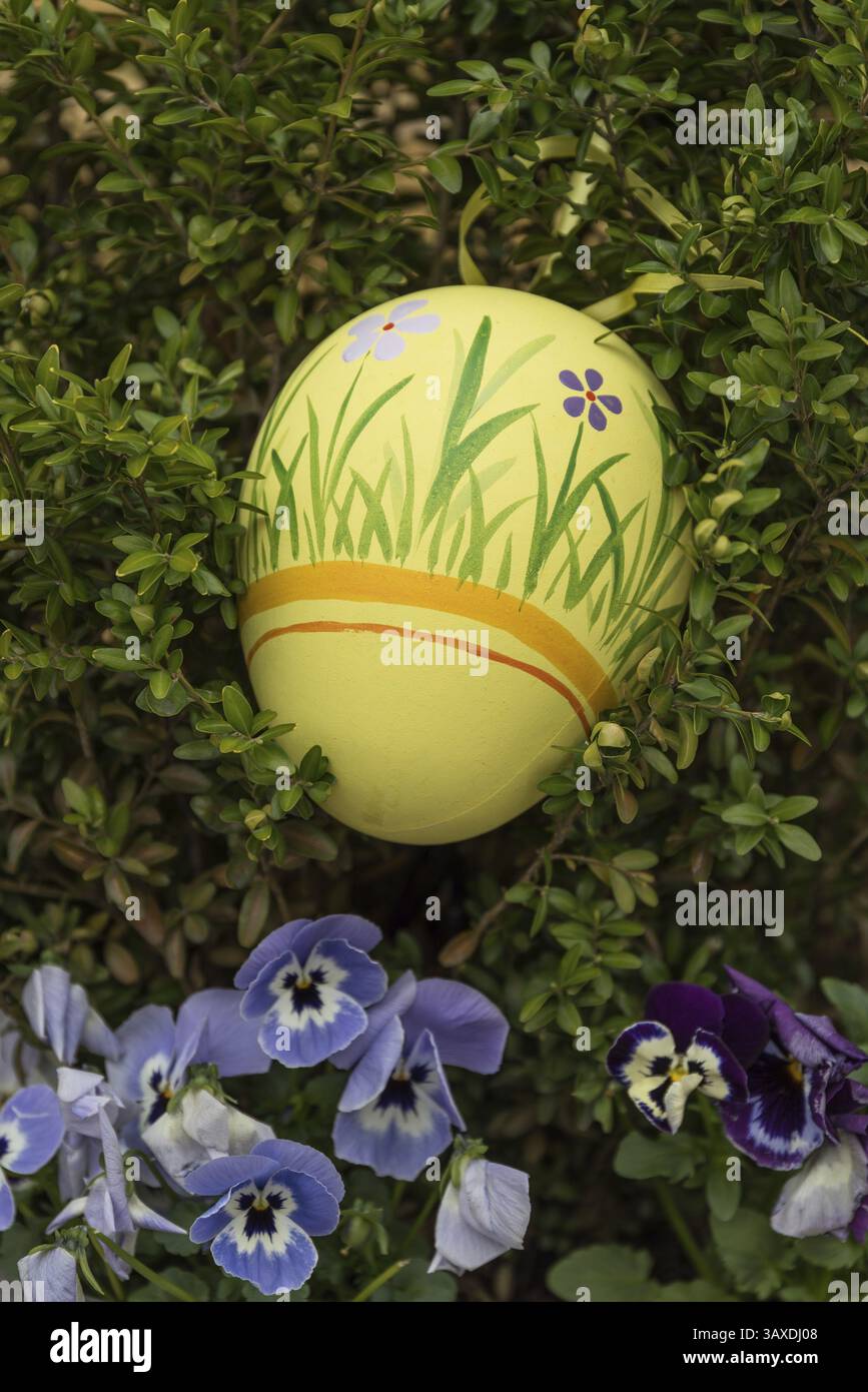Yellow coloured and hand-painted Easter egg for an Easter decoration Stock Photo
