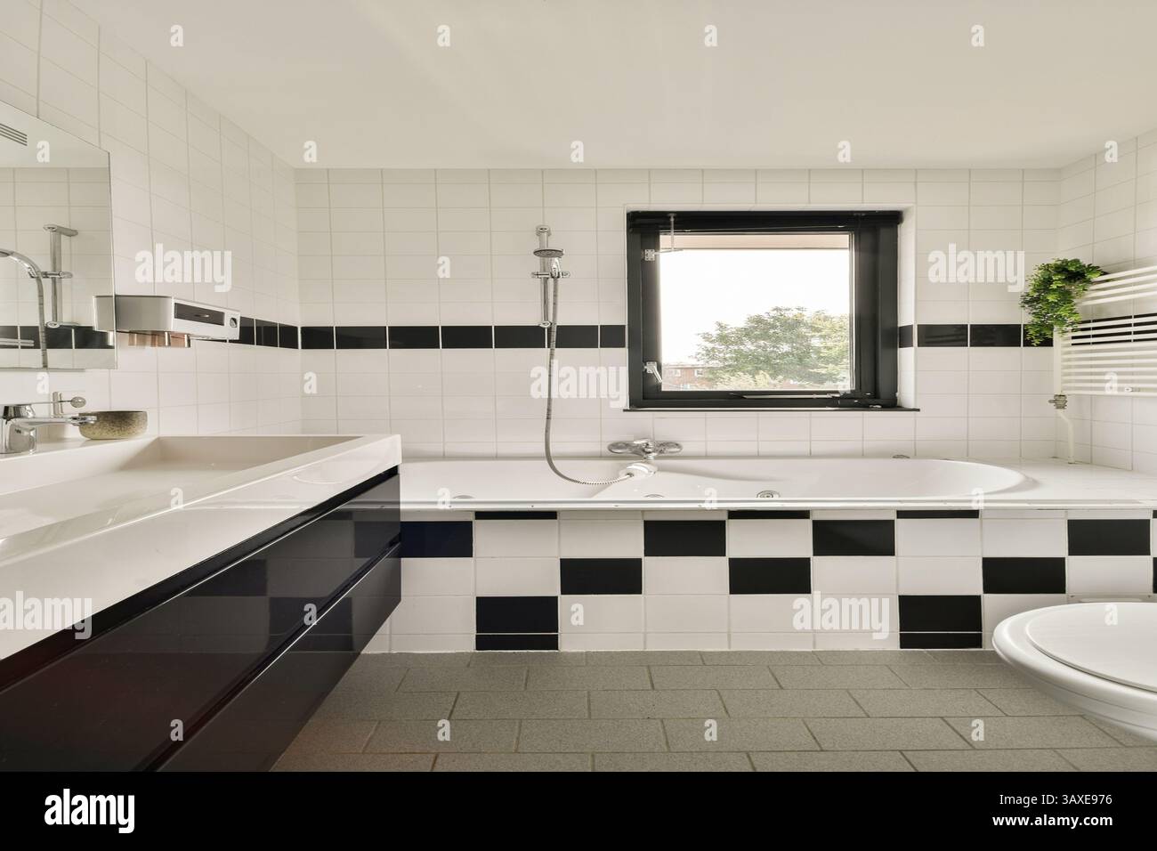 This stylish bathroom features a sleek design with black and white ...