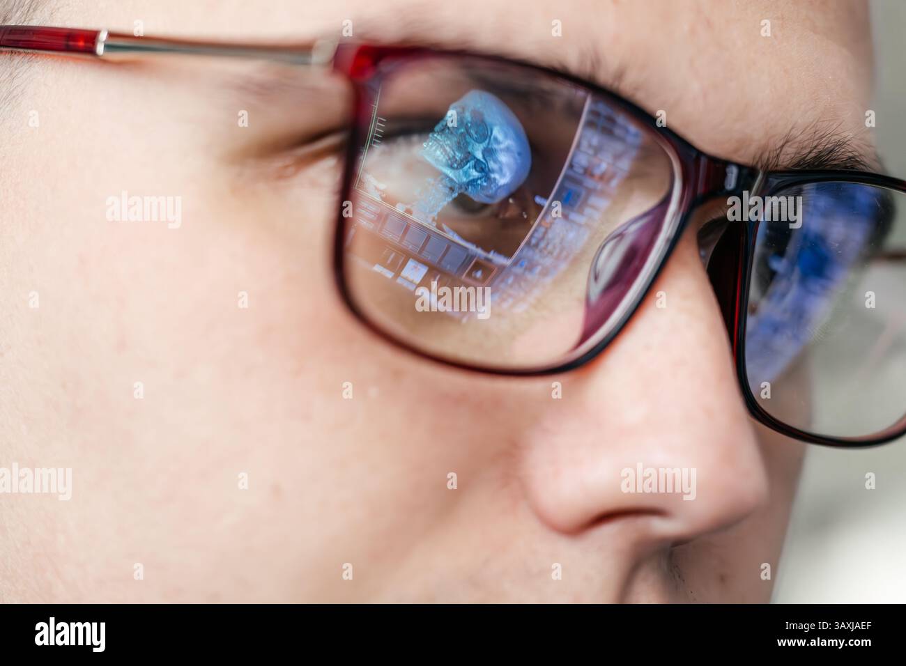 A specialist views MRI scans of the patient's brain, which are reflected in the glasses. The concept of modern technology and accurate diagnosis. Stock Photo