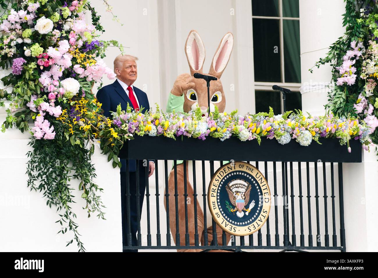 President Donald Trump is joined by a person in an Easter Rabbit ...