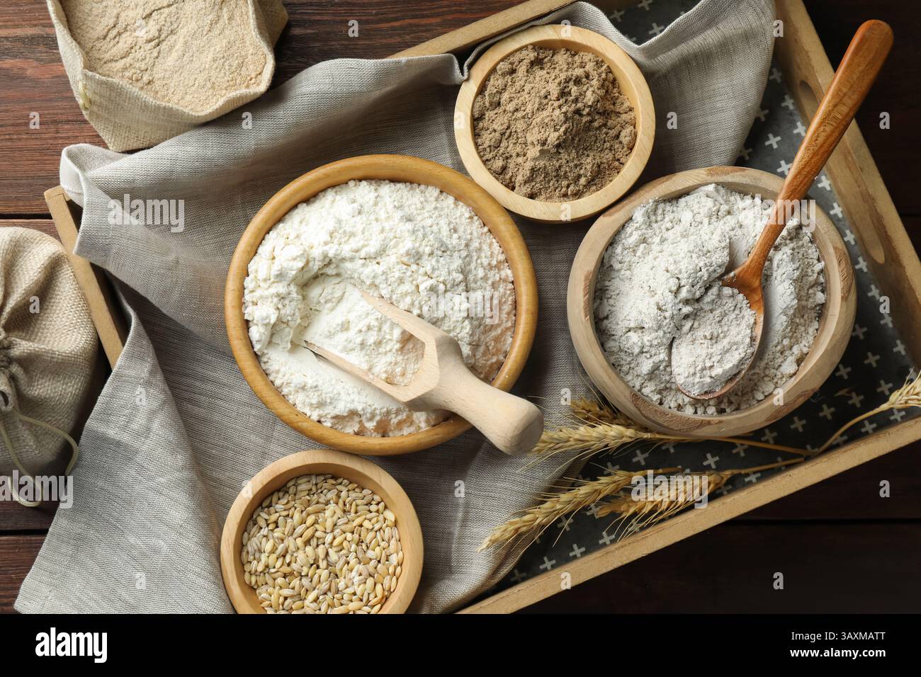 Different types of flour in bowls on wooden table, flat lay Stock Photo ...