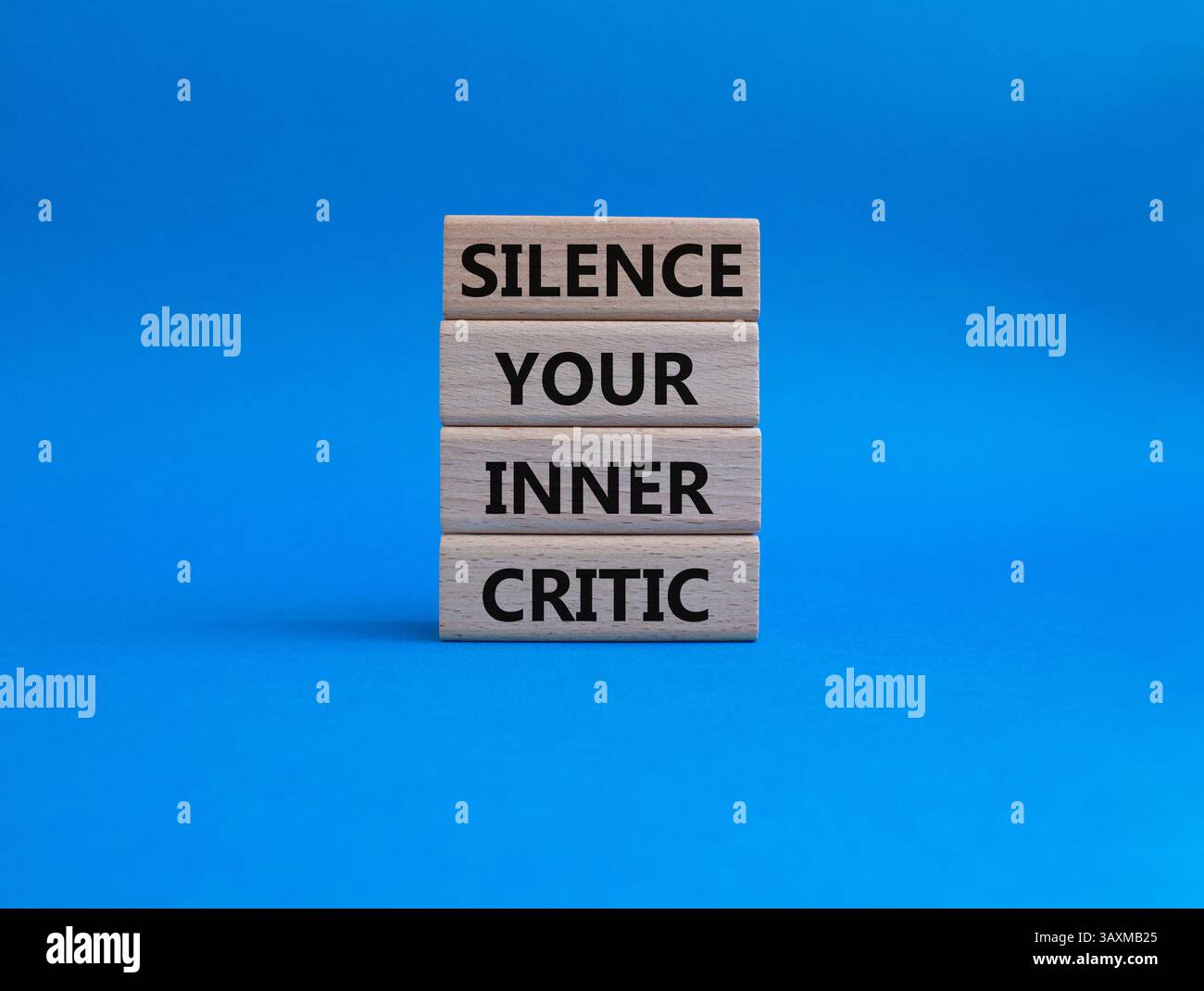 Picture of Silence your inner critic symbol. Wooden blocks with words Silence your ...