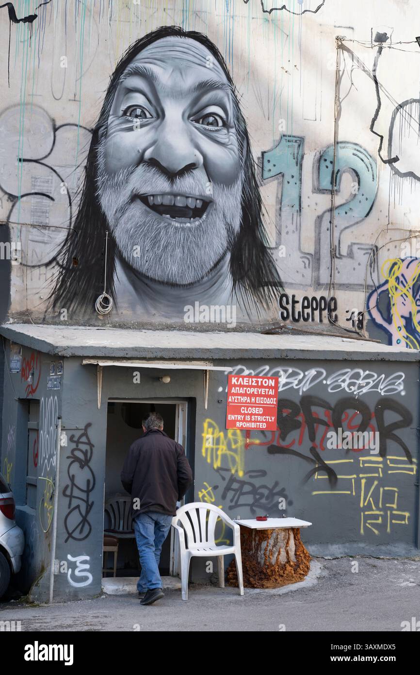 A mixture of street art  and graffiti cover a wall in the popular student district of  Exarcheia in Athens, Greece. Stock Photo
