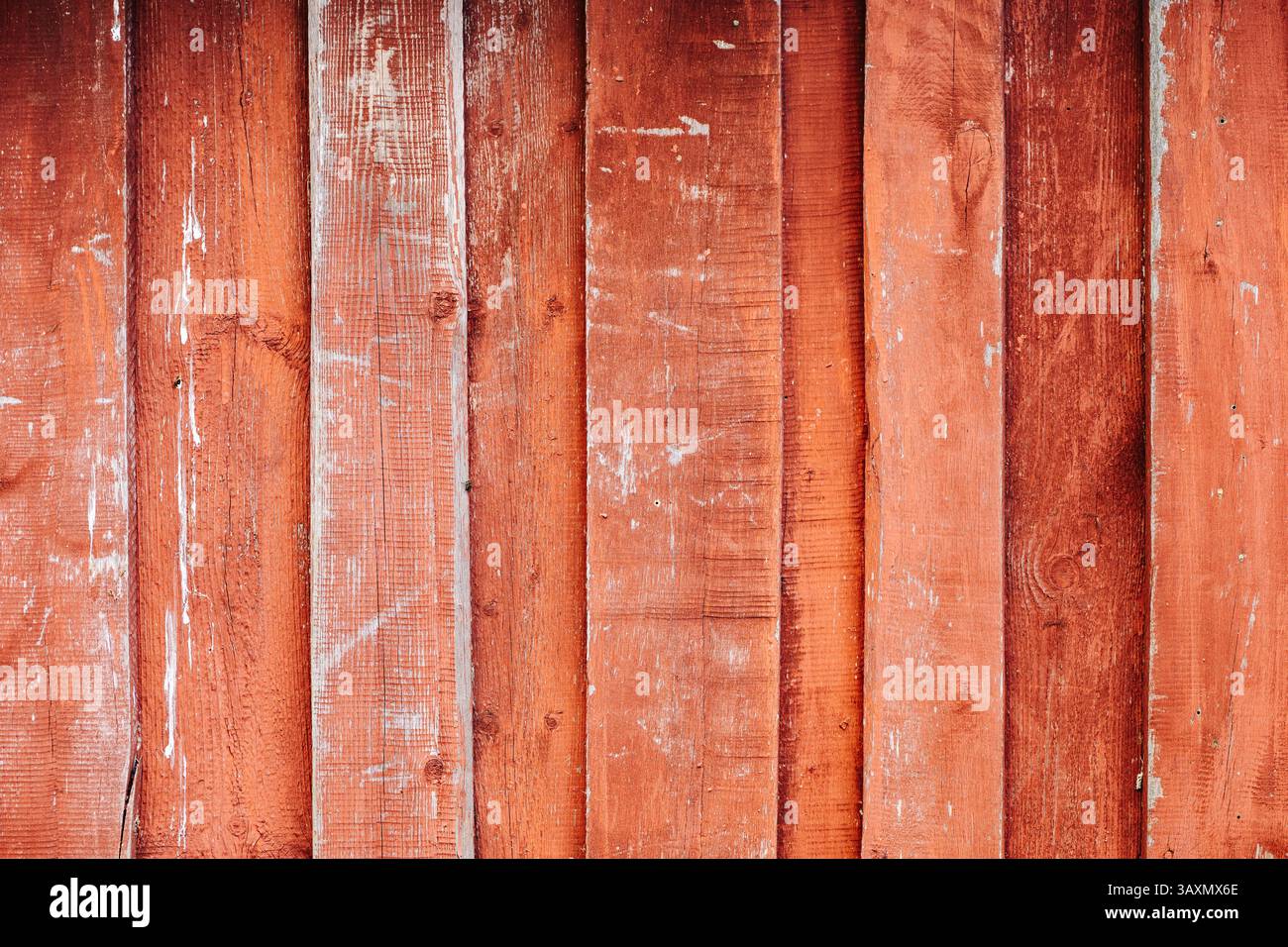 Red weathered wooden planks creating a rustic background Stock Photo
