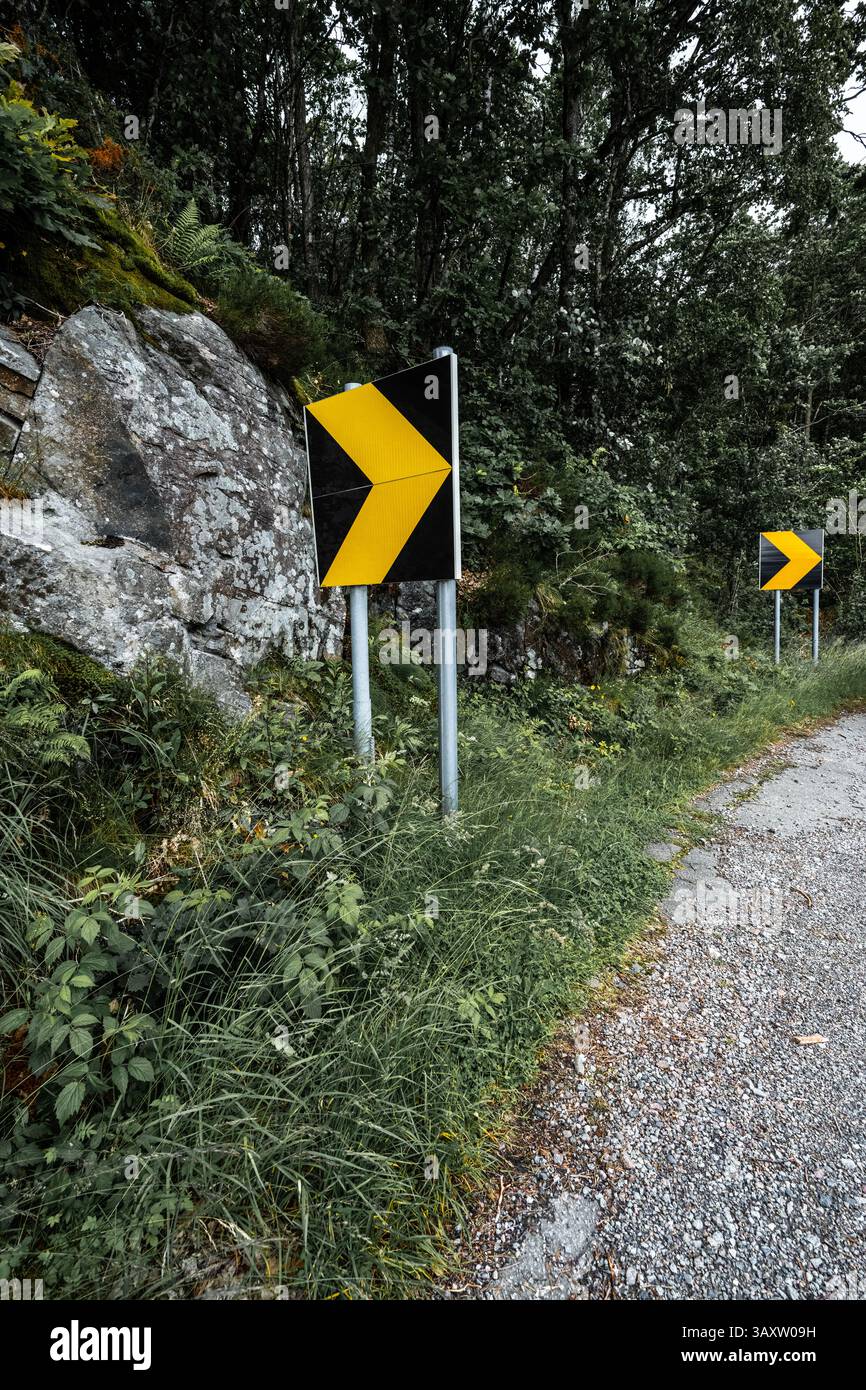 Warning signs in a tight and dangerous road curve Stock Photo - Alamy