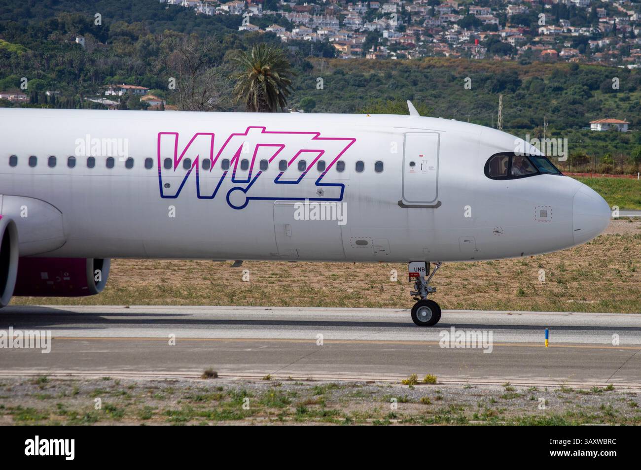 An Airbus A321 airliner from the UK-based airline Wizz Air UK taxiing at Málaga Costa del Sol Airport. Stock Photo