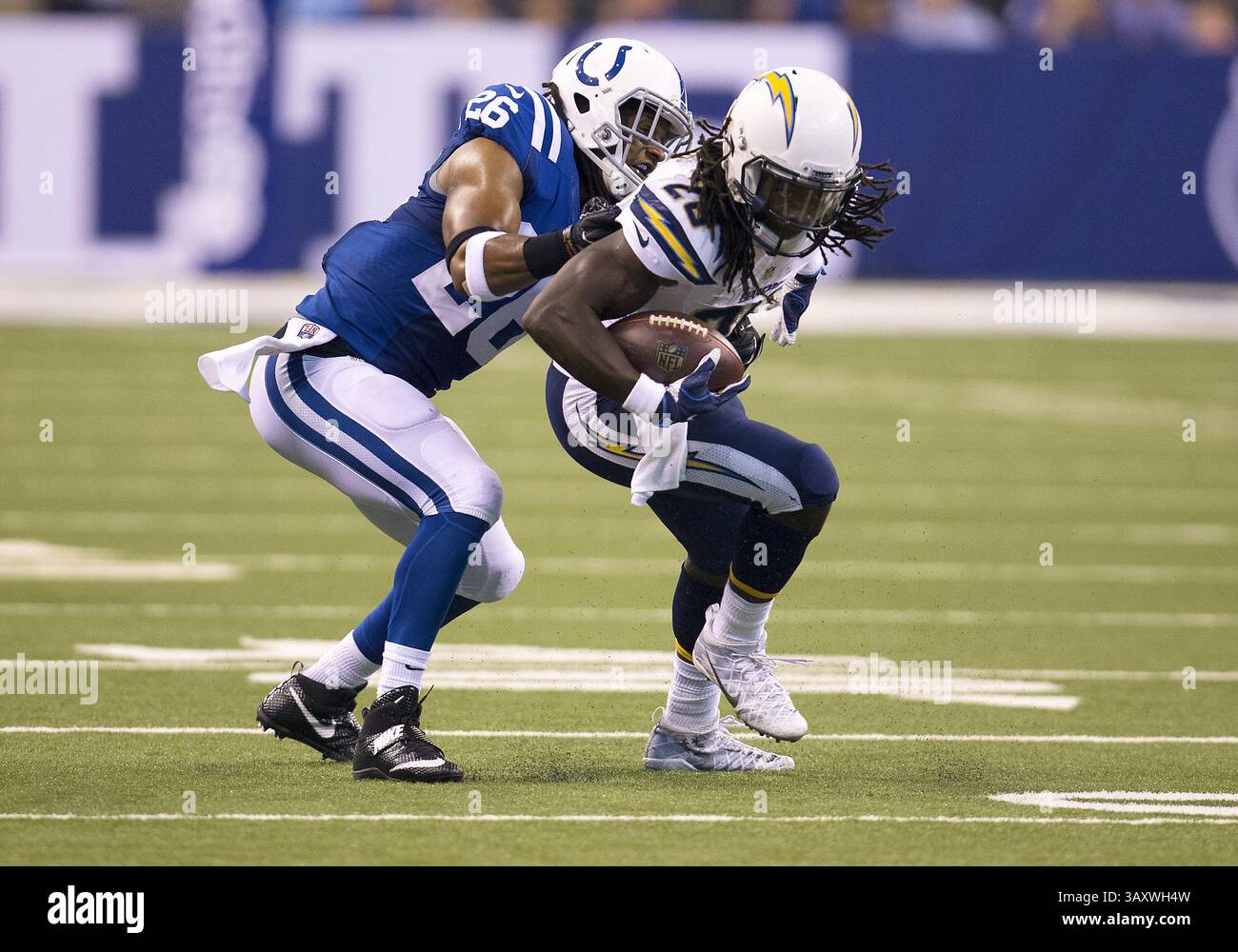 September 25, 2016: San Diego Chargers running back Melvin Gordon (28) runs with the ball as Indianapolis Colts safety Clayton Geathers (26) attempts to make the tackle during NFL football game action between the San Diego Chargers and the Indianapolis Colts at Lucas Oil Stadium in Indianapolis, Indiana. Indianapolis defeated San Diego 26-22. John Mersits/CSM.(Credit Image: &copy; John Mersits/Cal Sport Media via ZUMA Wire) Stock Photo