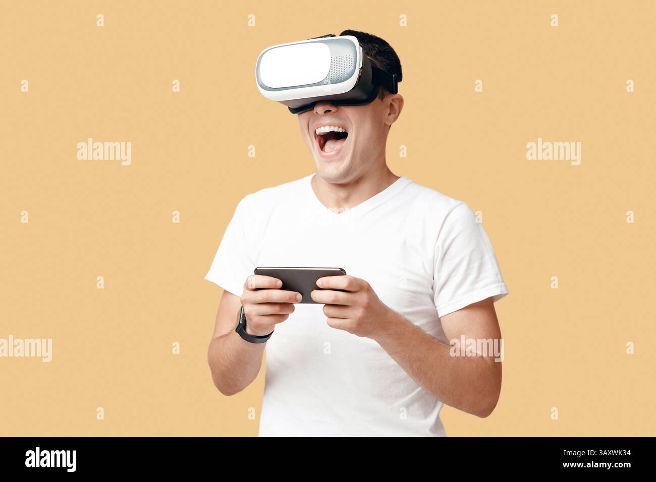 Virtual gadgets for entertainment, man using VR and phone Stock Photo