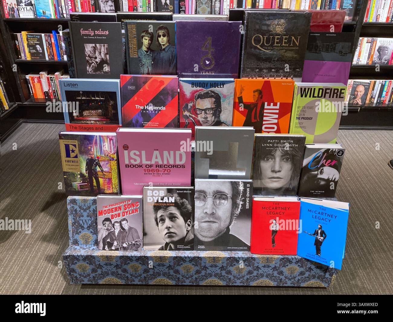 Factual Hardback books of famous rock and roll bands and pop stars for sale at the book store Stock Photo