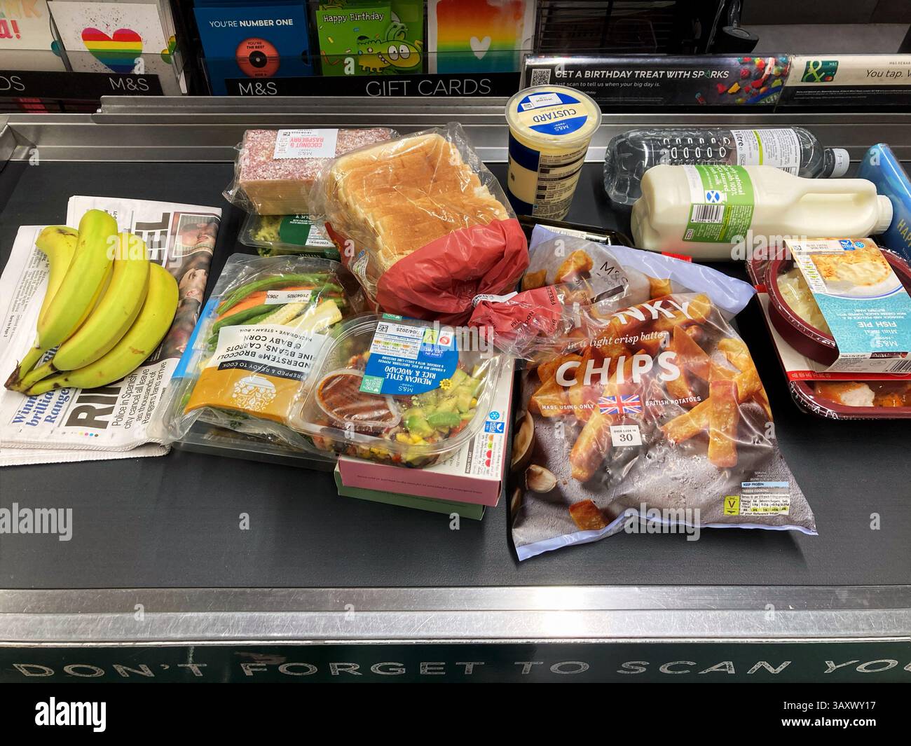At the Marks and Spencer checkout with shopping, UK - Smartphone Captured Stock Image