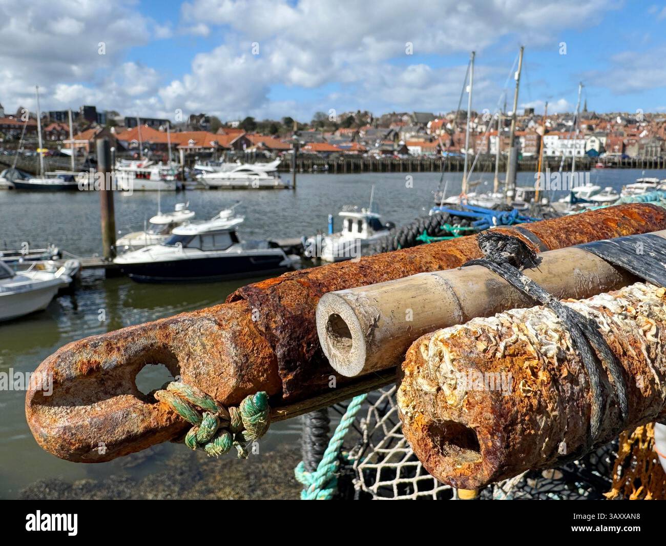 Fishing industry in Whitby lobster pots and ropes on Church Street looking onto the River Esk Stock Photo
