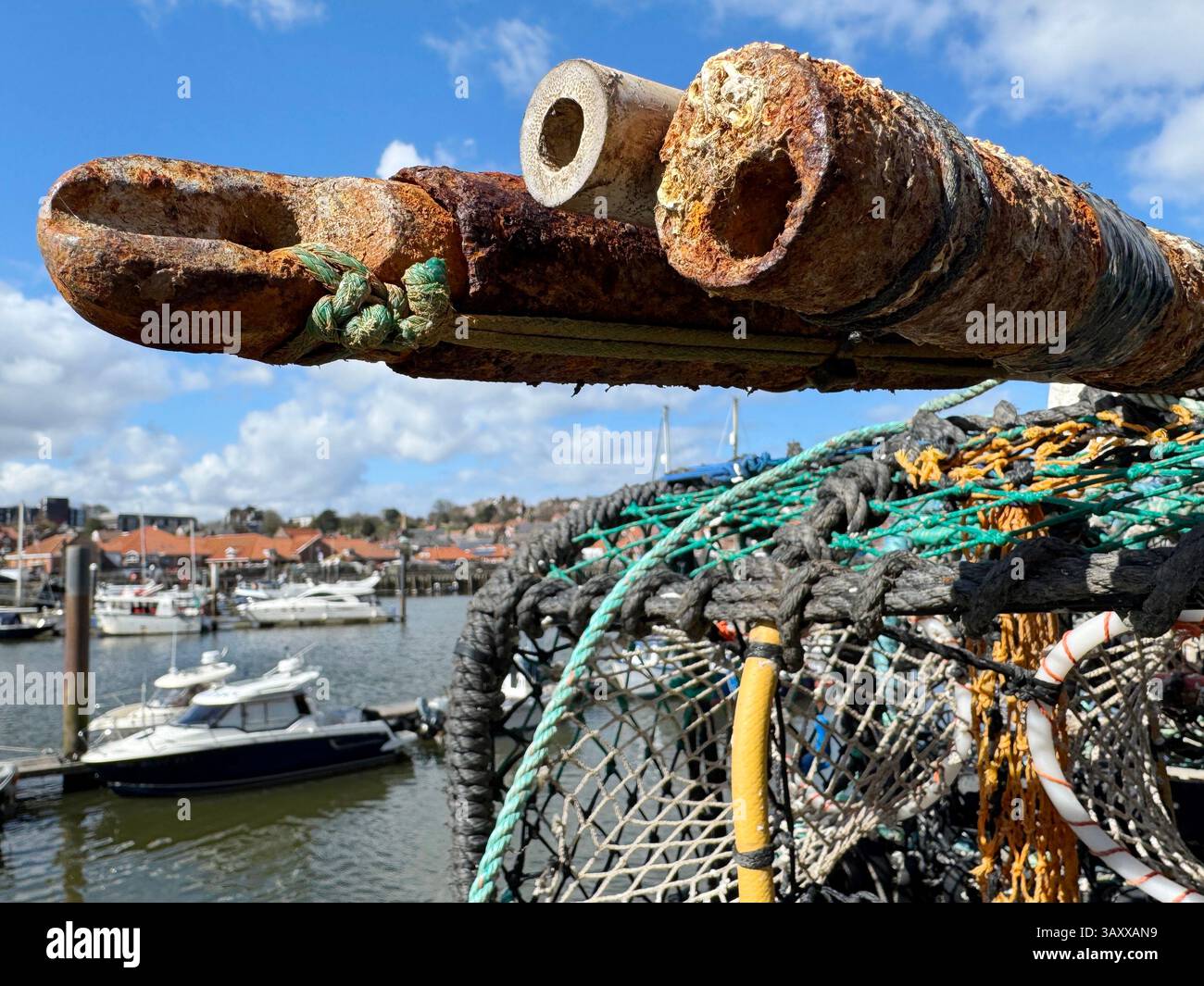 Fishing industry in Whitby lobster pots and ropes on Church Street looking onto the River Esk Stock Photo