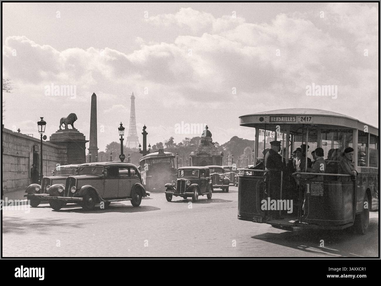 Vintage 1936 Paris with cars and city trams Paris. Street scene at the Place de la Concorde with cars and trams busy traffic Date: 1935 Location: France, Paris Photographer: Poll, Willem van de Stock Photo