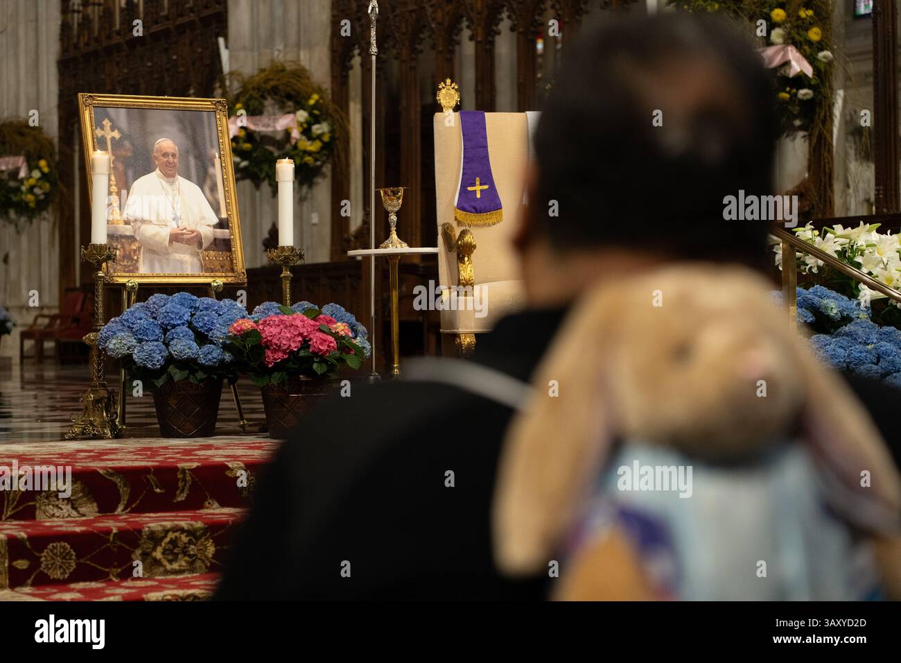 A man with a rabbit backpack mourns the death of Pope Francis at St ...