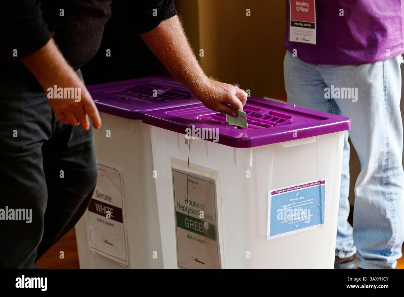 A person places their ballot into a box at a polling centre during ...