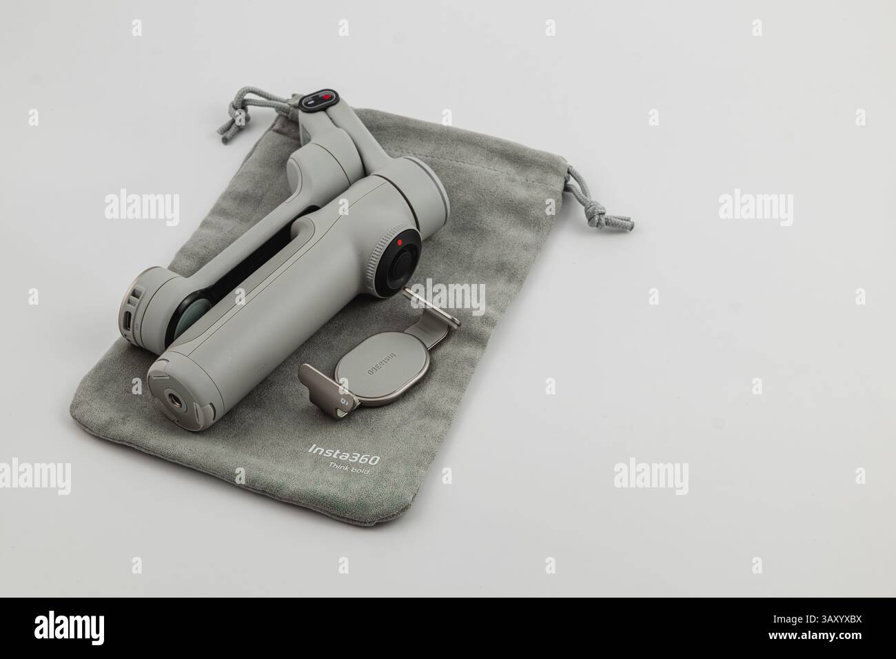 Lviv Ukraine 08.04.25 A compact grey handheld camera stabilizer lies on a soft pouch. This innovative tool is designed for capturing smooth videos, sh Stock Photo