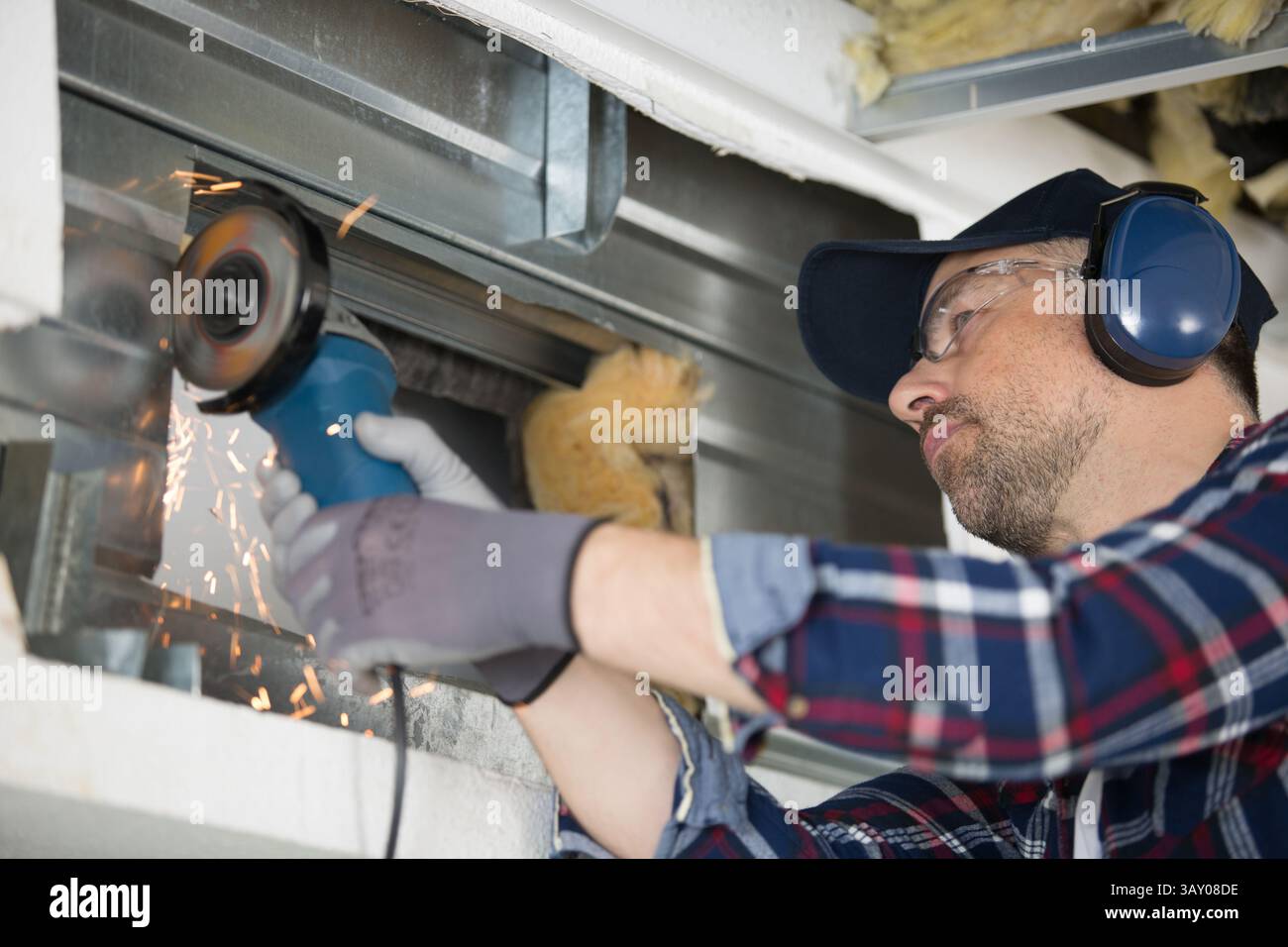 sparks flying as builder uses angle grinder Stock Photo