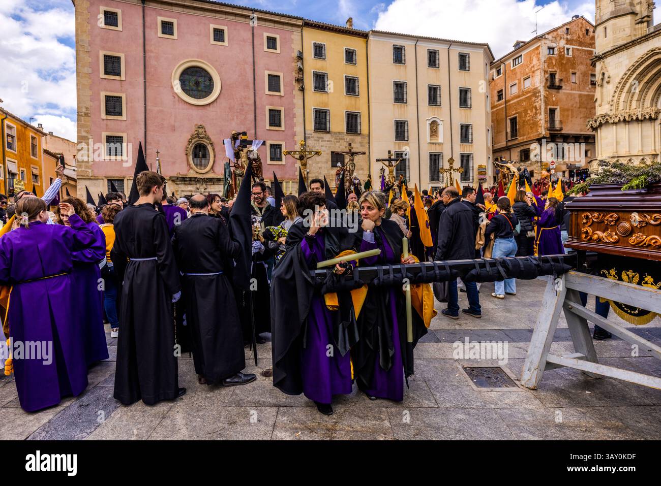 Good Friday procession En el Calvario in Cuenca. Participants in the Good Friday procession En el Calvario in Cuenca take a break in front of the cathedral. Plaza Mayor, Cuenca, Castile-La Mancha, Spain Stock Photo