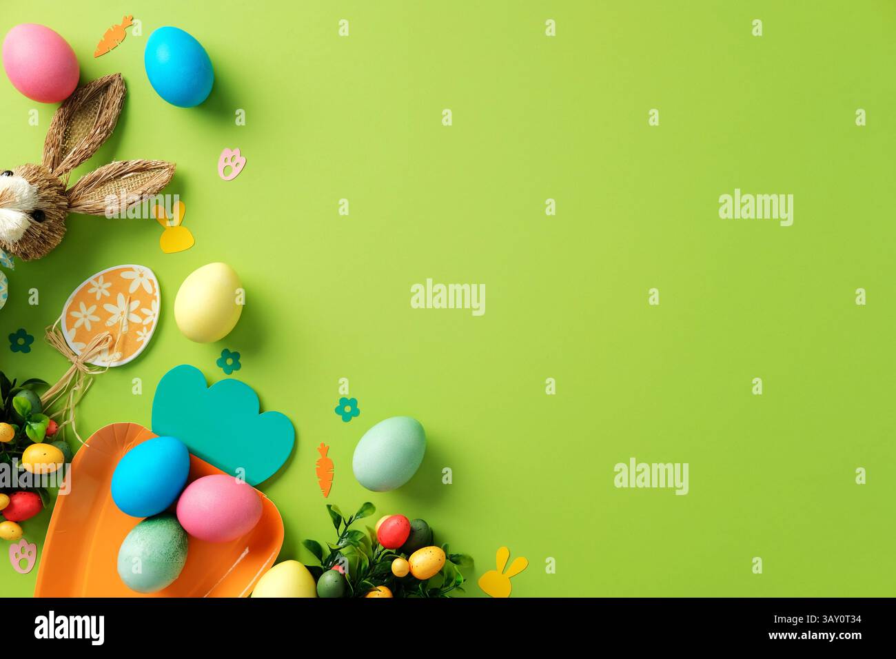 Easter layout with Easter bunny, tulips, colorful eggs on green background Stock Photo
