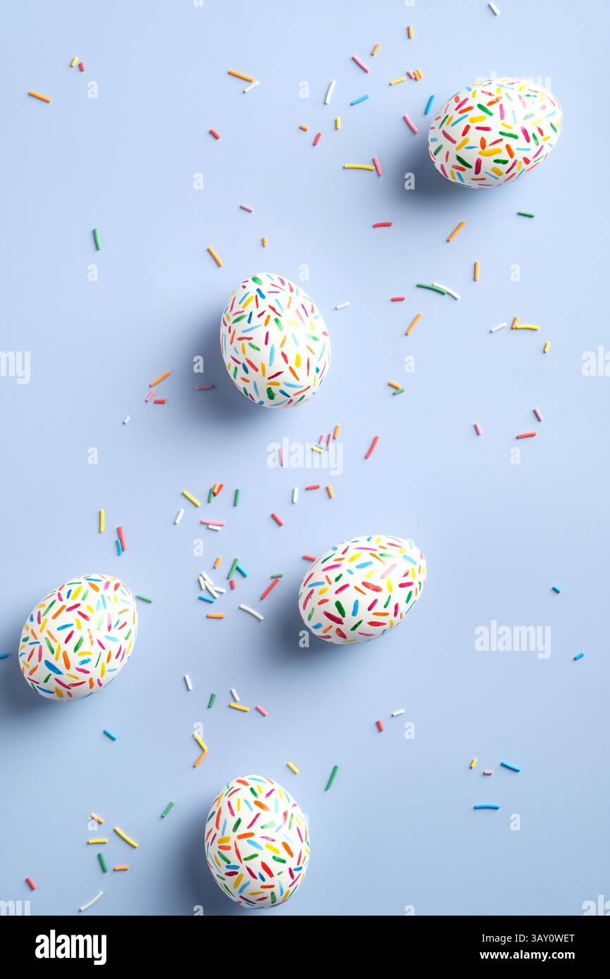 Colorful easter eggs on pastel blue background. Flat lay composition, view from above. Stock Photo