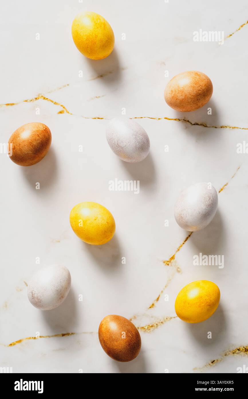 Luxury Easter eggs on marble table. Flat lay, top view, vertical Stock Photo