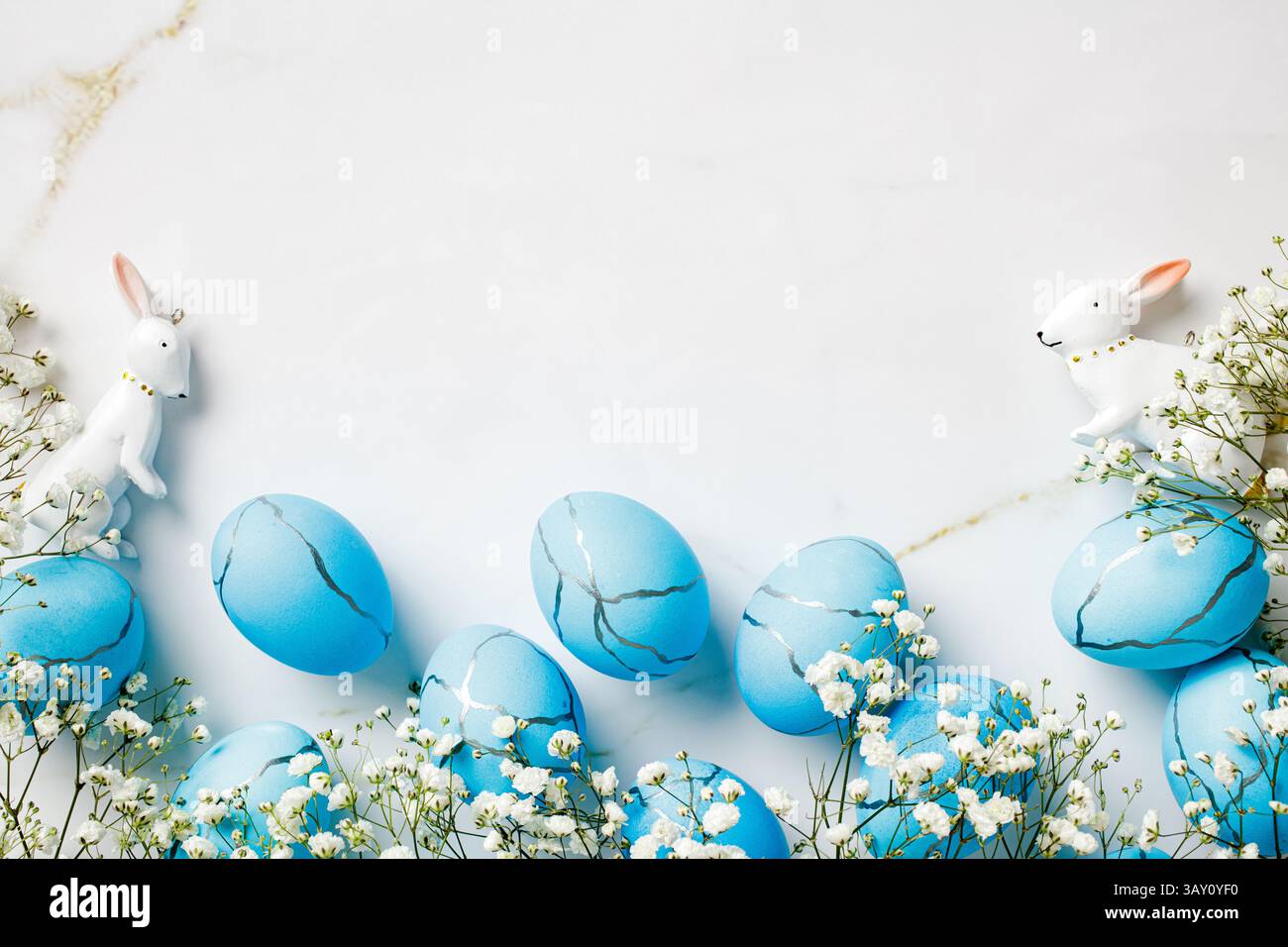 Blue and white Easter scene with a bunny, Easter eggs, spring flowers Stock Photo