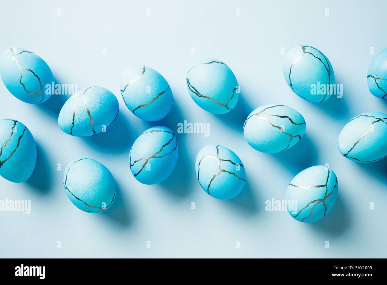 Blue Easter eggs painted marble texture on light blue background. Flat lay, top view. Stock Photo
