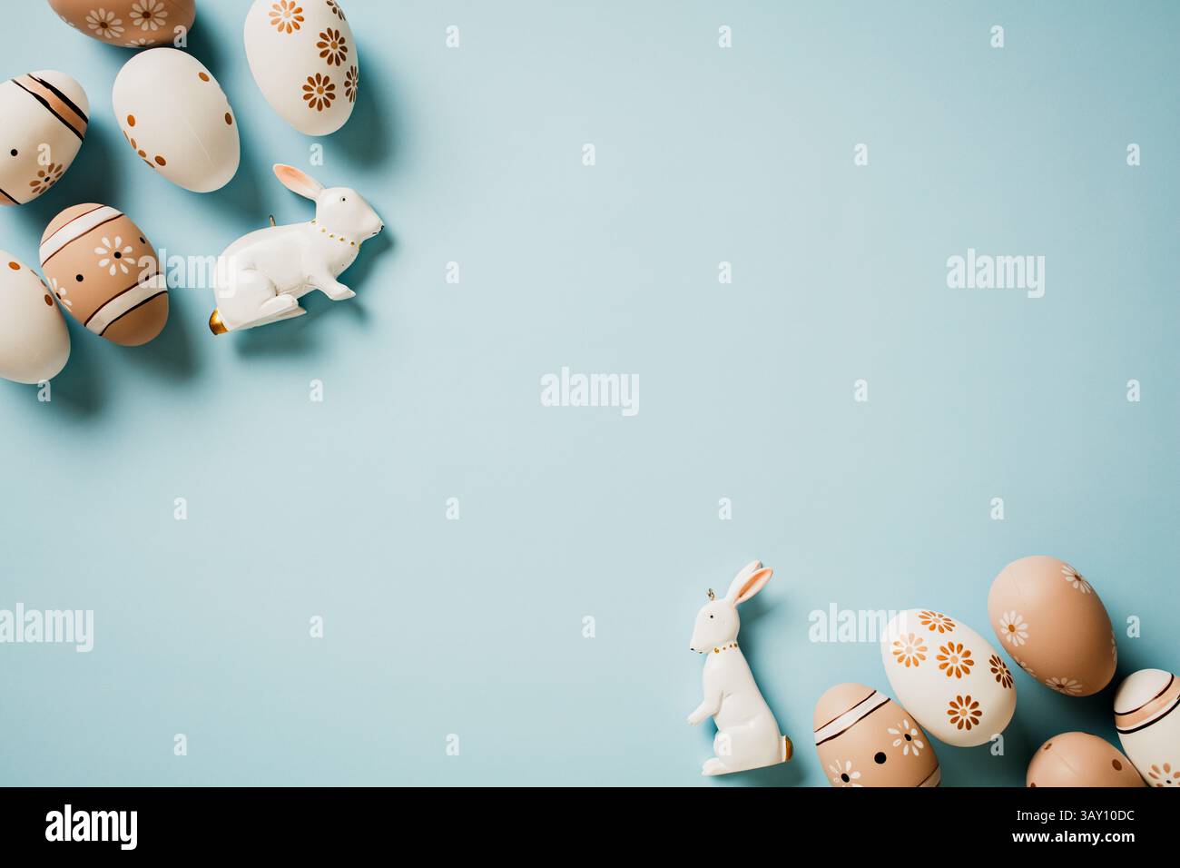 Elegant Easter card. Flat lay brown and white eggs with rabbits on ...
