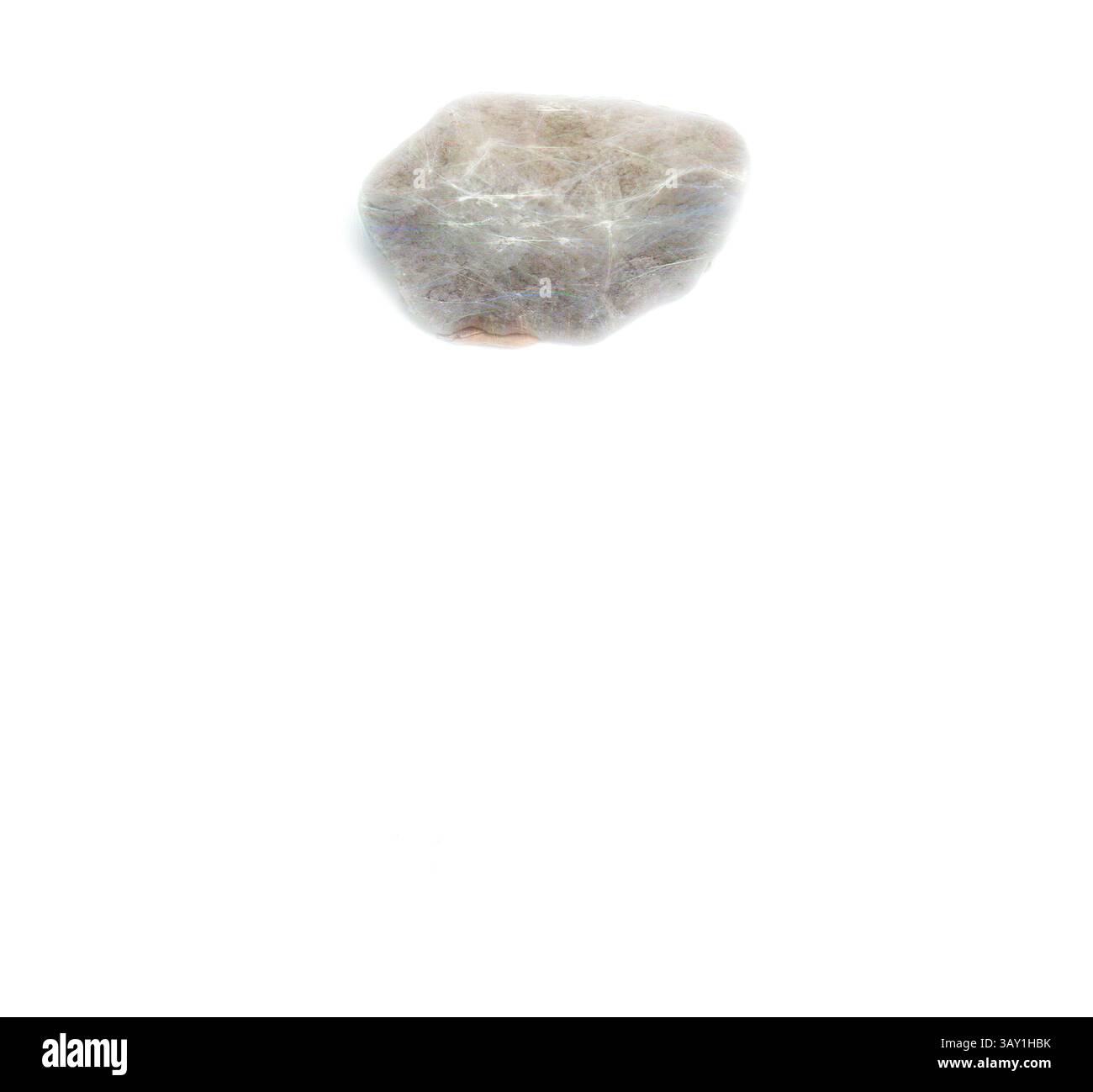 A smooth, rounded stone rests against a plain background, showcasing ...