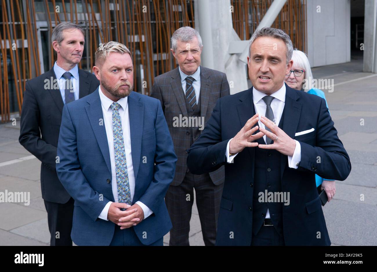 Edinburgh, Scotland UK. 22nd  April 2025. Alex Cole Hamilton MSP  introduces new recruit to the Scottish Liberal Democrats, Jamie Greene MSP , outside the Scottish Parliament today. Mr Greens defected from the Scottish Conservatives whom he described as moving to the far-right. Iain Masterton/Alamy Live News Stock Photo