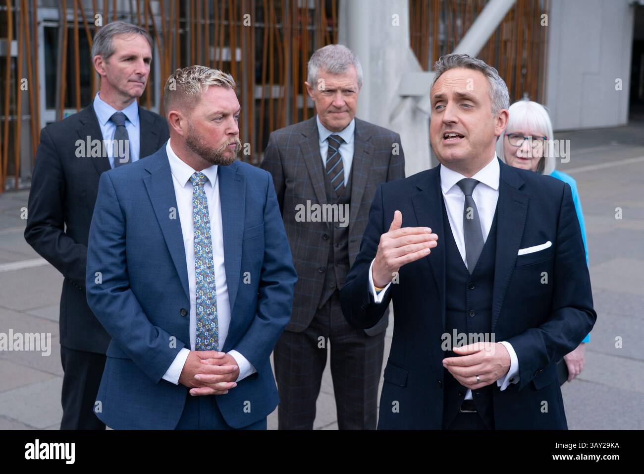 Edinburgh, Scotland UK. 22nd  April 2025. Alex Cole Hamilton MSP  introduces new recruit to the Scottish Liberal Democrats, Jamie Greene MSP , outside the Scottish Parliament today. Mr Greens defected from the Scottish Conservatives whom he described as moving to the far-right. Iain Masterton/Alamy Live News Stock Photo