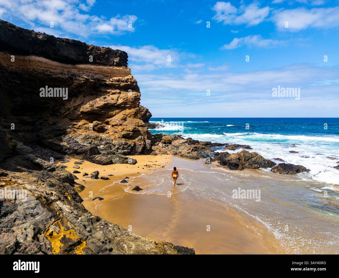 Woman walking on foamy shore hi-res stock photography and images - Alamy
