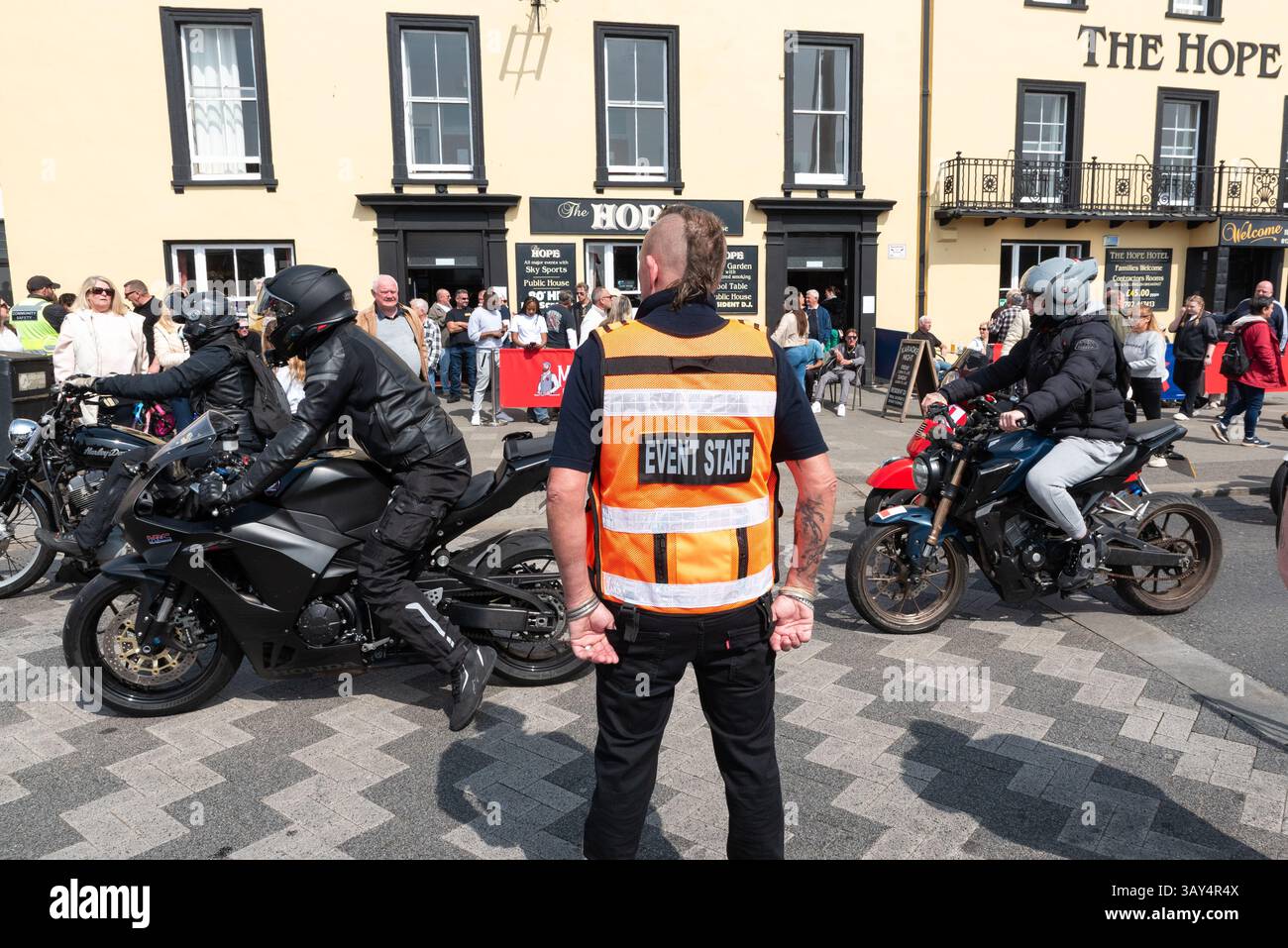 Southend Shakedown motorcycle rally along the seafront of Southend on Sea, Essex, UK. Event staff member organising arriving motorcycles Stock Photo