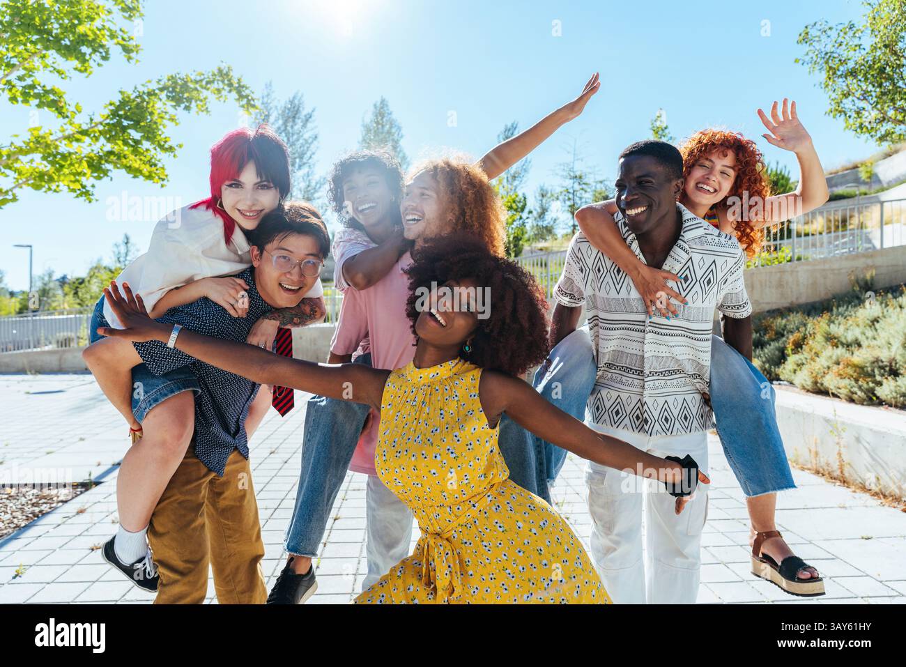 Multiethnic group of young friends meeting and having fun outdoors ...