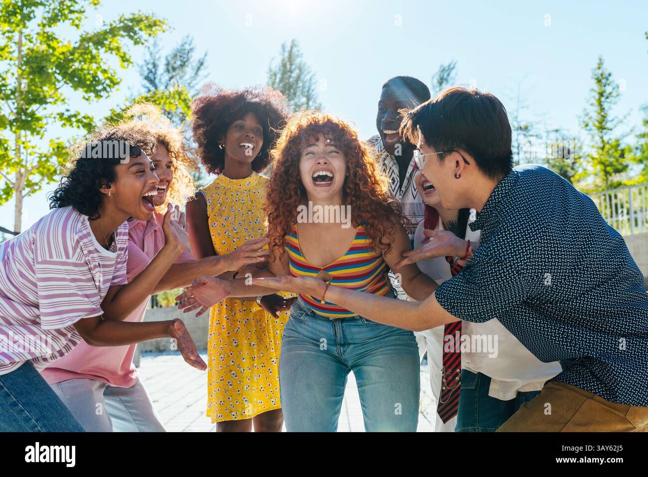 Multiethnic group of young friends meeting and having fun outdoors ...