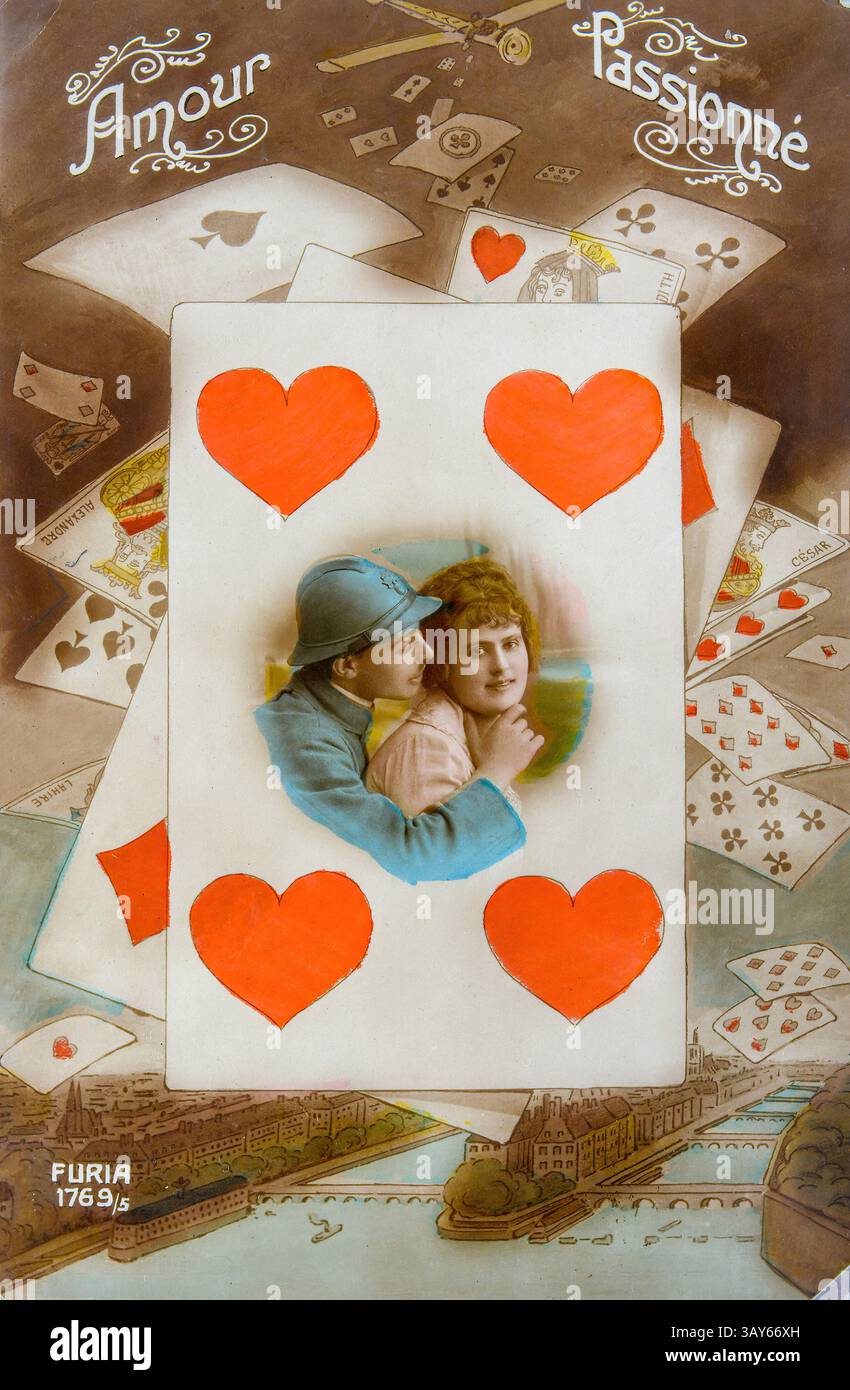 Lovers occupy the center of the postcard, surrounded by scattered playing cards. The dominant hearts symbolize love, while historical design elements Stock Photo