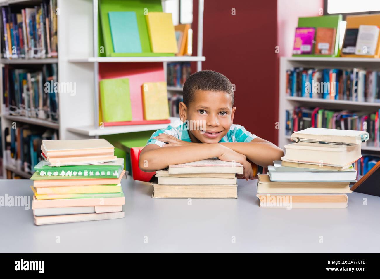 Portrait of kids leaning on books in library at school Stock Photo - Alamy