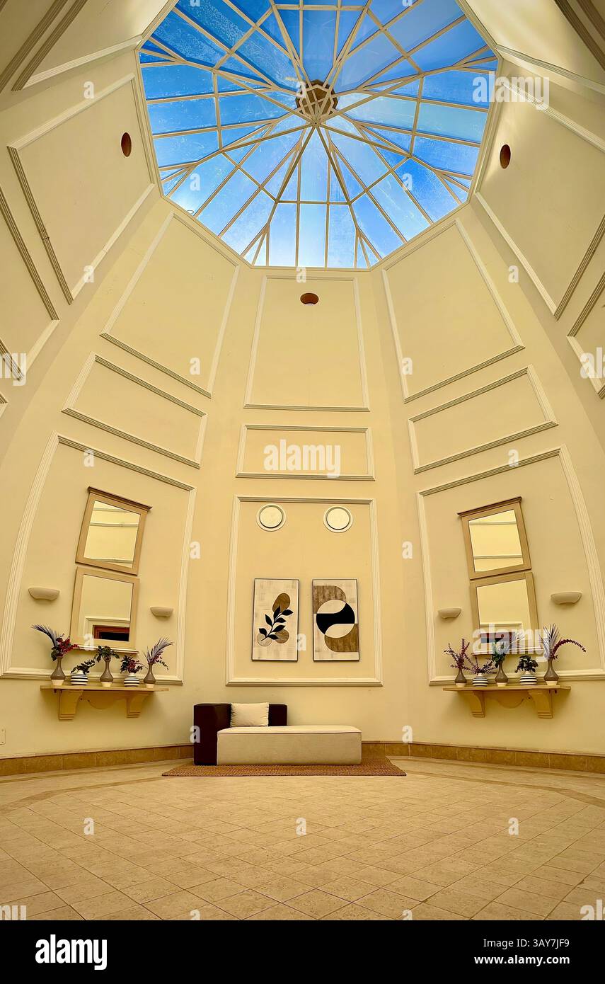 This elegant interior features a spacious room with high ceilings and a striking dome skylight that floods the space with natural light. The minimalis - Smartphone Captured Stock Image