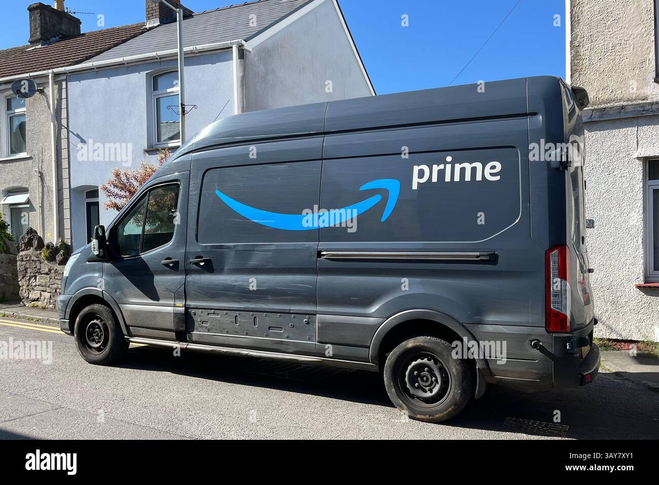 An Amazon Prime Delivery Van parked on a street in Mumbles. Swansea, Wales, United Kingdom. 21st April 2025. - Smartphone Captured Stock Image