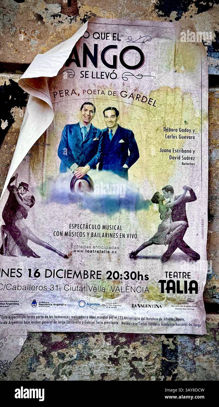 Old and partially torn tango event poster on a weathered wall in Valencia, Spain. The poster advertises a musical performance with dancers and musicia - Smartphone Captured Stock Image