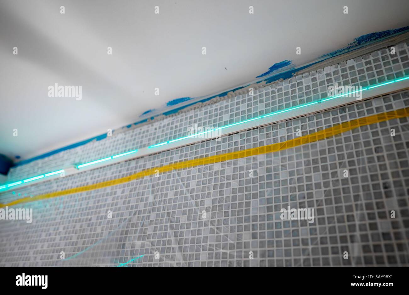 Laser-Guided Ceiling Installation in Progress in Bathroom. Stock Photo