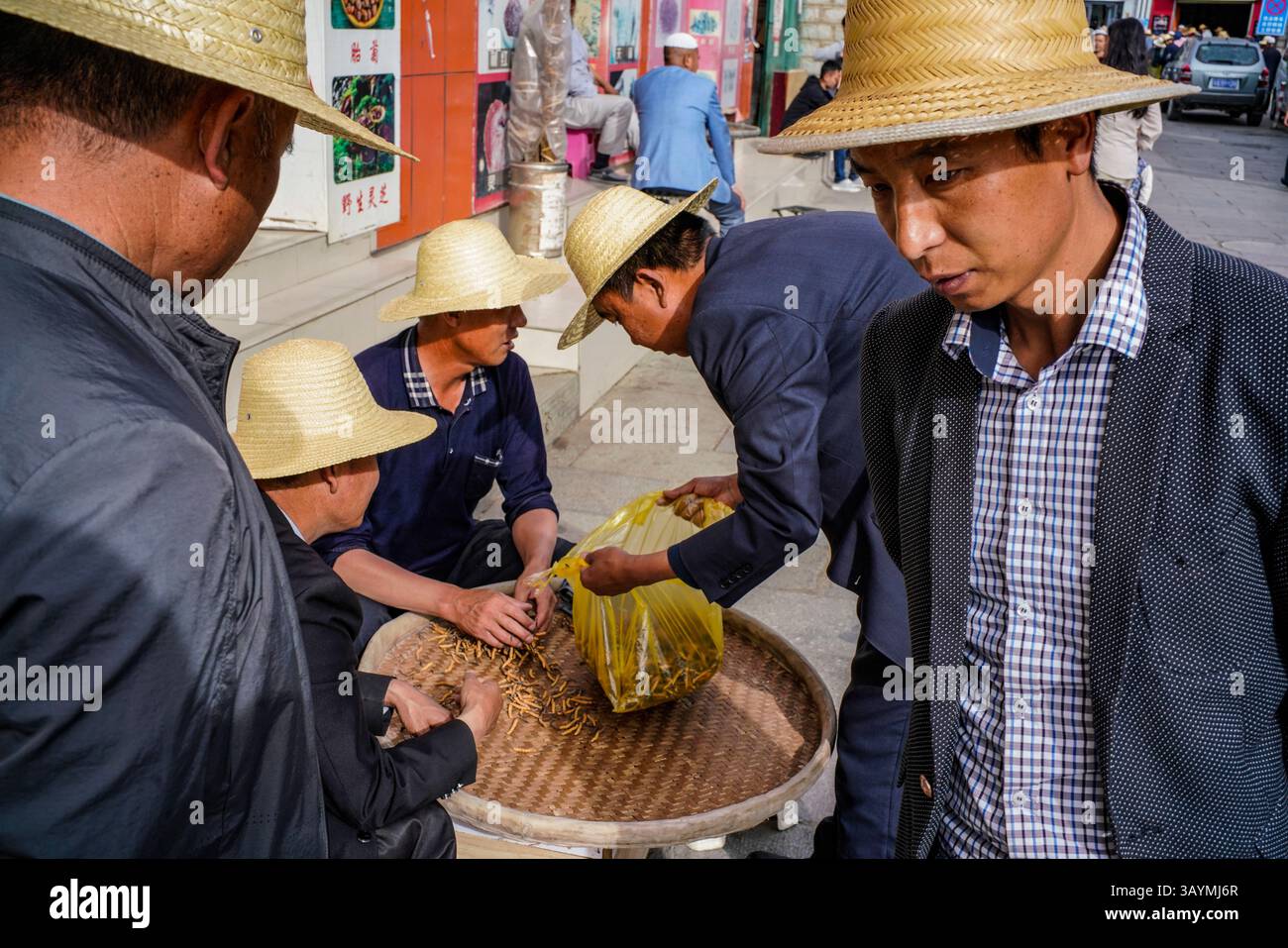 A close-up scene from a bustling Tibetan market in Lhasa, where local ...