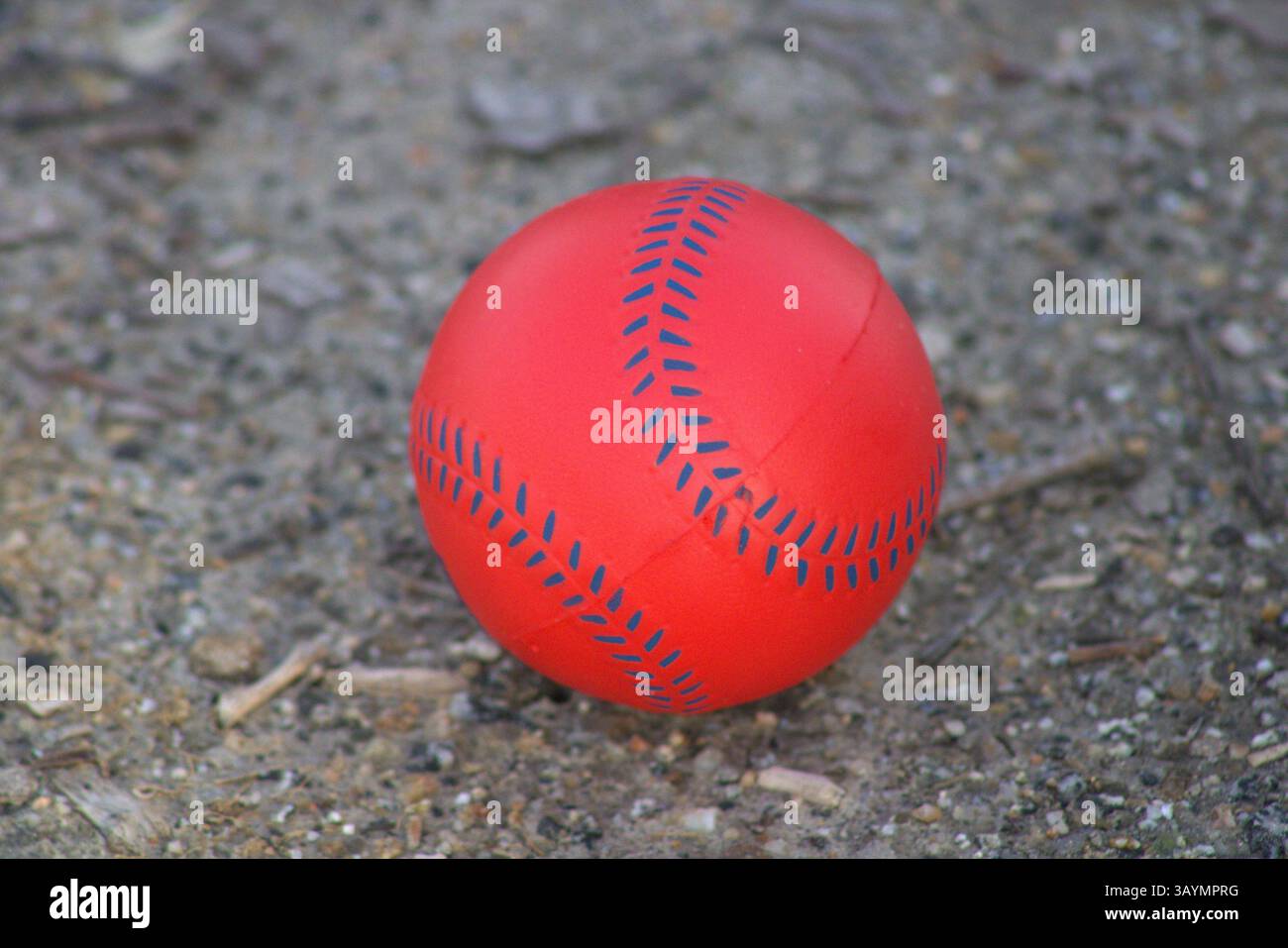 red baseball with navy stitching Stock Photo
