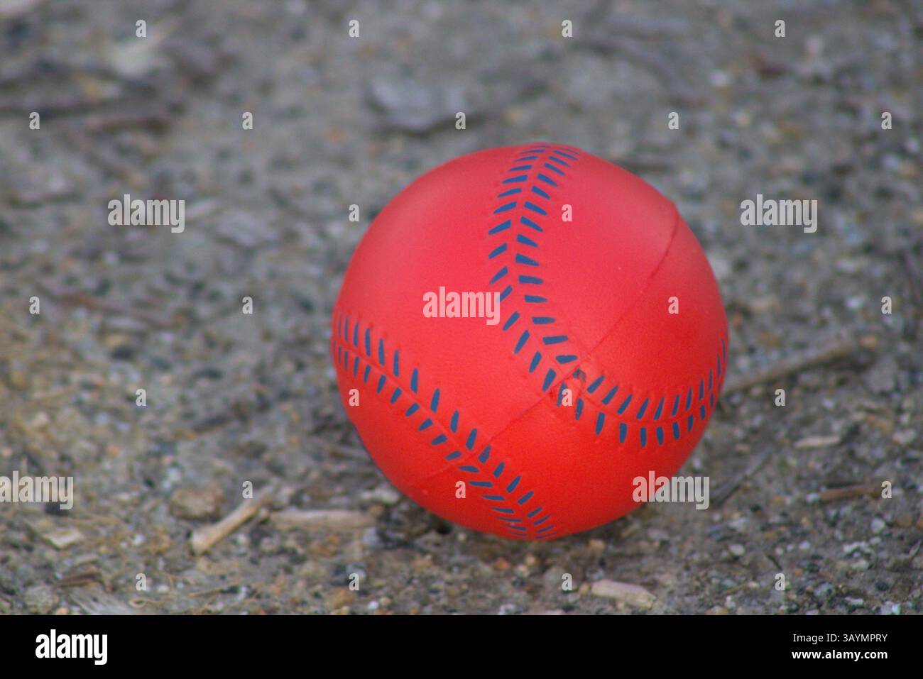 red baseball with navy stitching Stock Photo