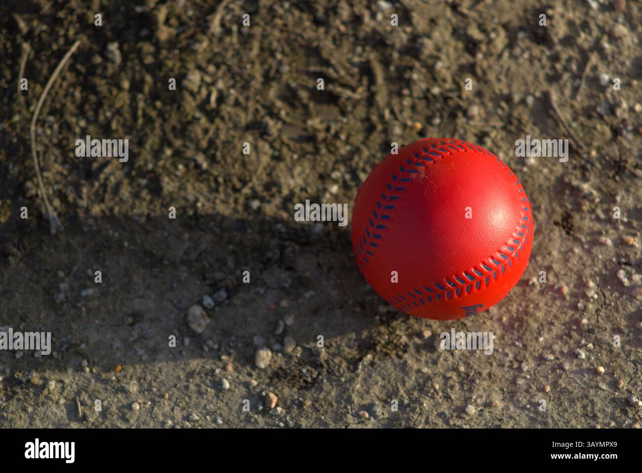red baseball with navy stitching Stock Photo