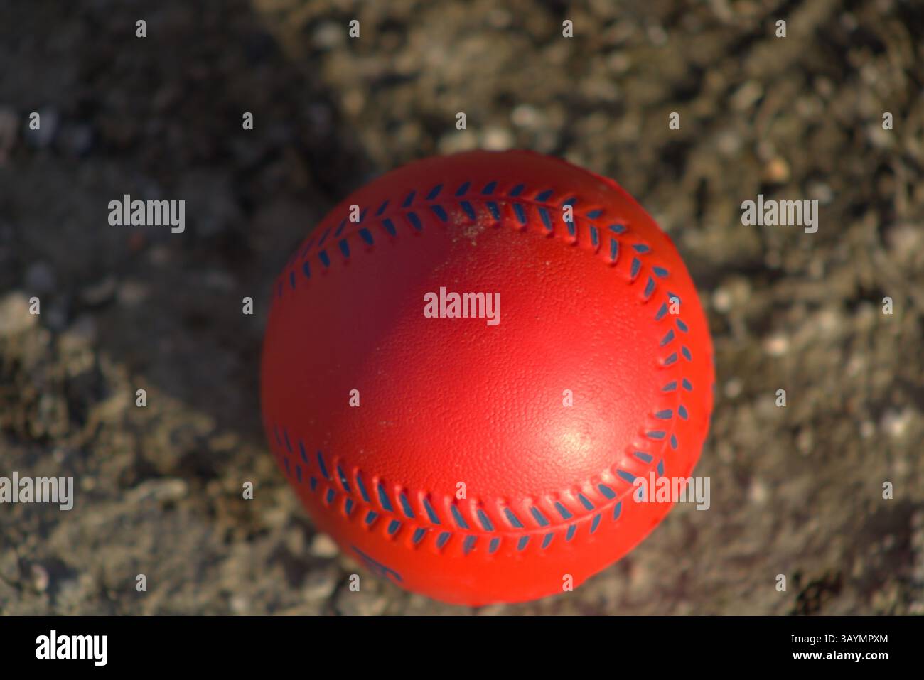 red baseball with navy stitching Stock Photo