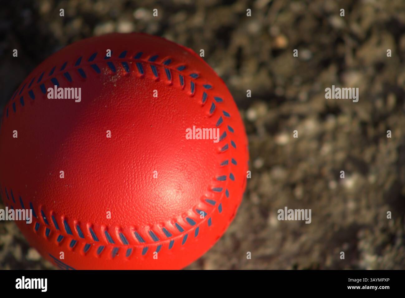 red baseball with navy stitching Stock Photo