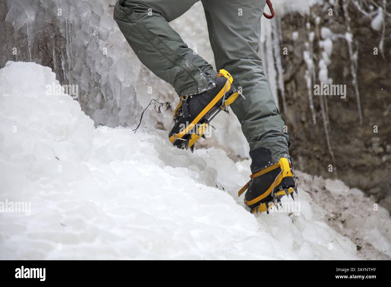 Pair of alpinist boots in crampons on ice Stock Photo